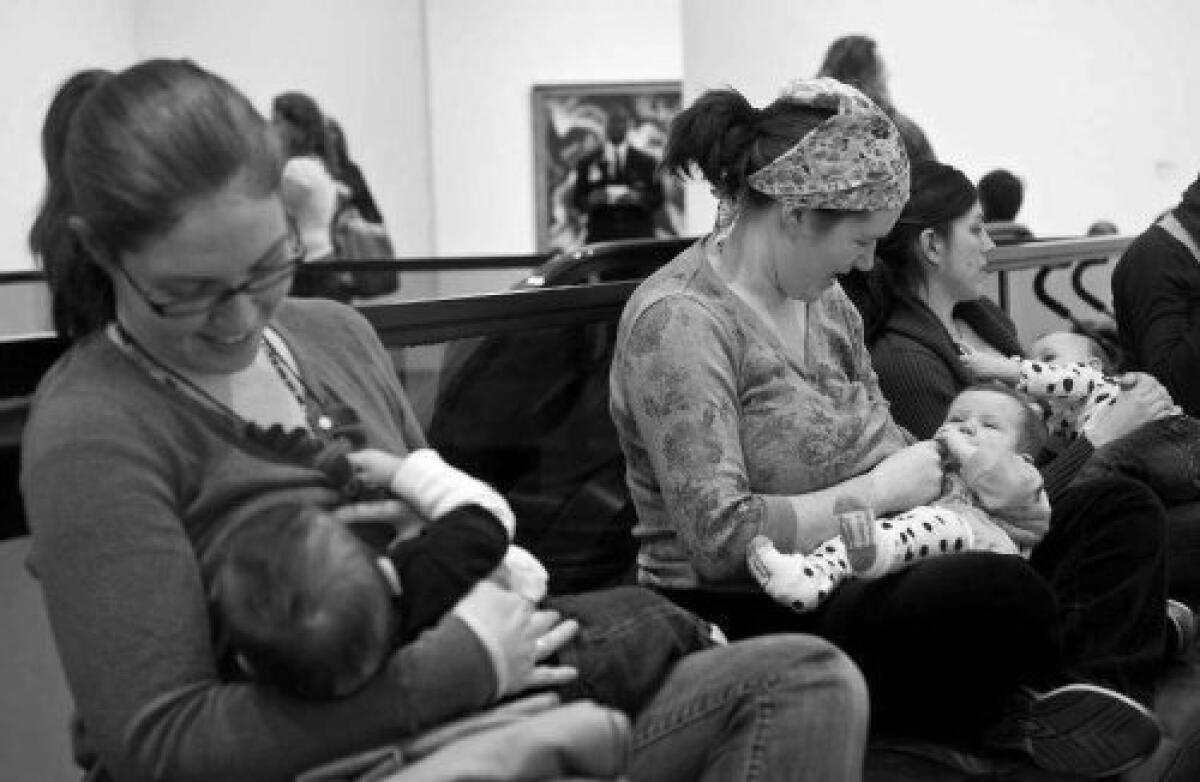 Women are seen breastfeeding their babies at the Hirshhorn Museum in Washington during a "nurse-in" organized after a woman was stopped from nursing in public by museum security guards.