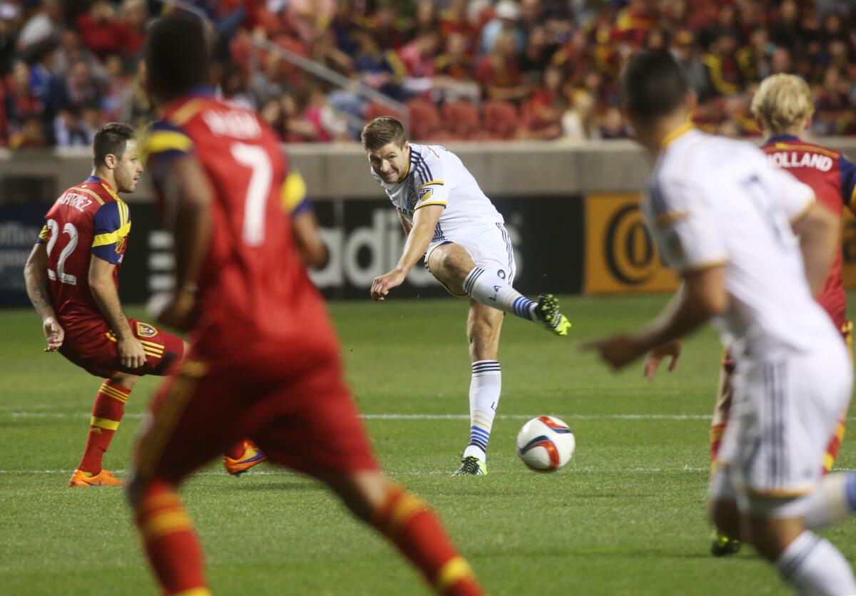 Galaxy’s Steven Gerrard, middle, passes the ball as he is defended by Real Salt Lake's Juan Manuel Martinez on Saturday night.