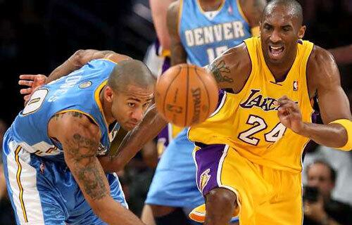 Nuggets guard Dahntay Jones goes for a steal against Lakers guard Kobe Bryant in the first half Wednesday night.