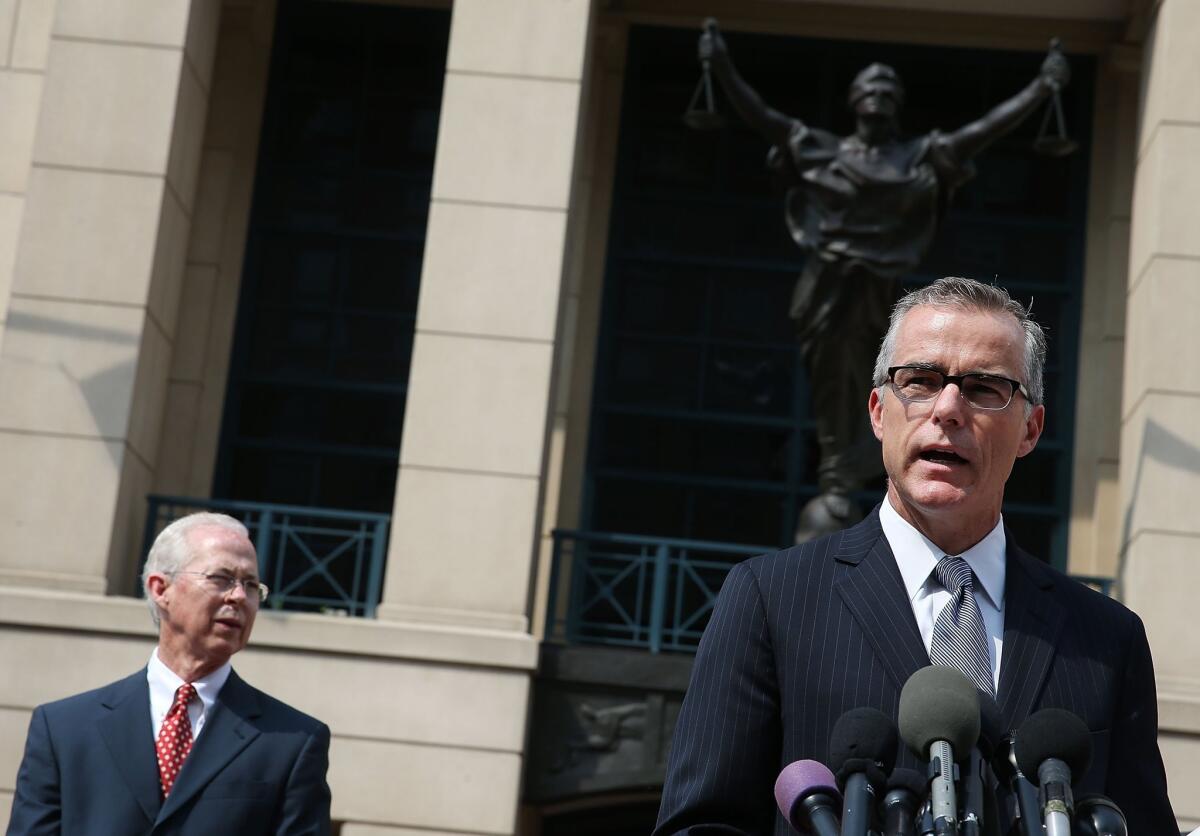Andrew G. McCabe, assistant director of the FBI's Washington field office, speaks while flanked by Dana J. Boente, U.S. attorney for the Eastern District of Virginia, after a hearing in federal court June 11 in Alexandria, Va.