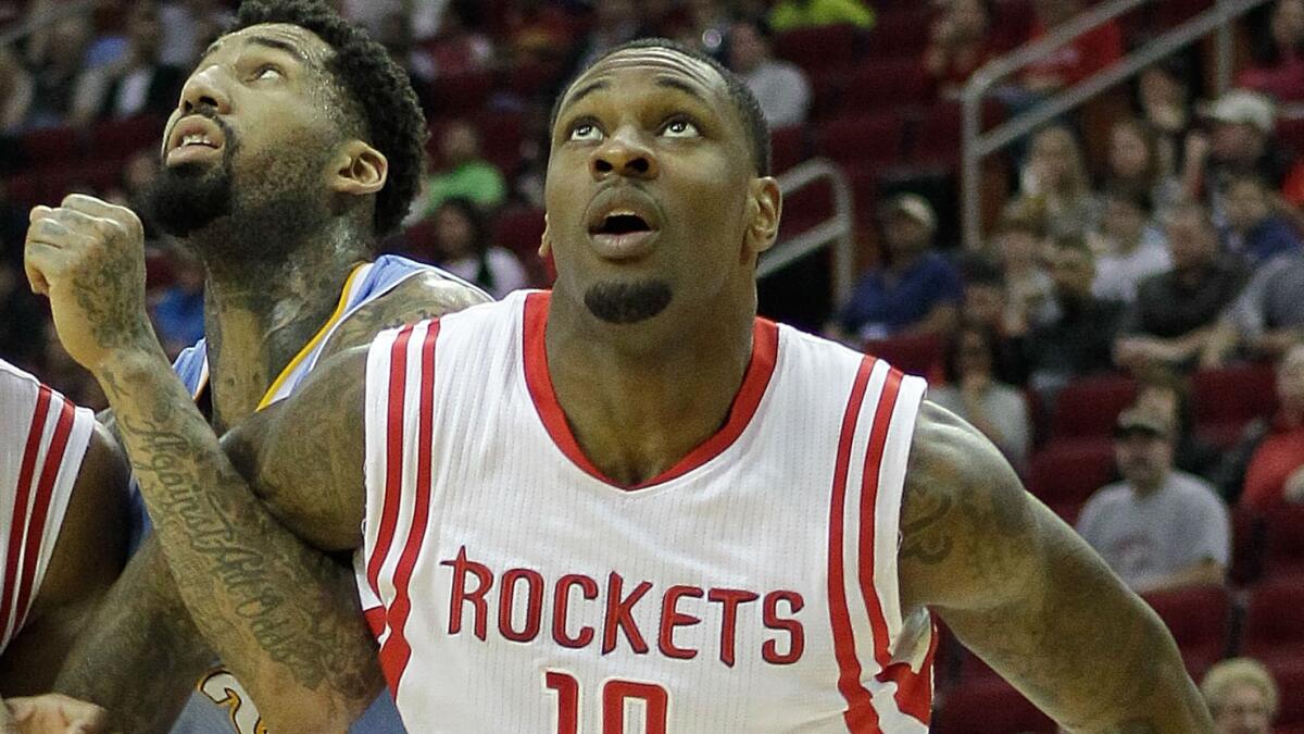 Houston Rockets forward Tarik Black, right, blocks out Denver Nuggets forward Wilson Chandler during a Rockets' win on Dec. 13. Black was acquired by the Lakers on Sunday.