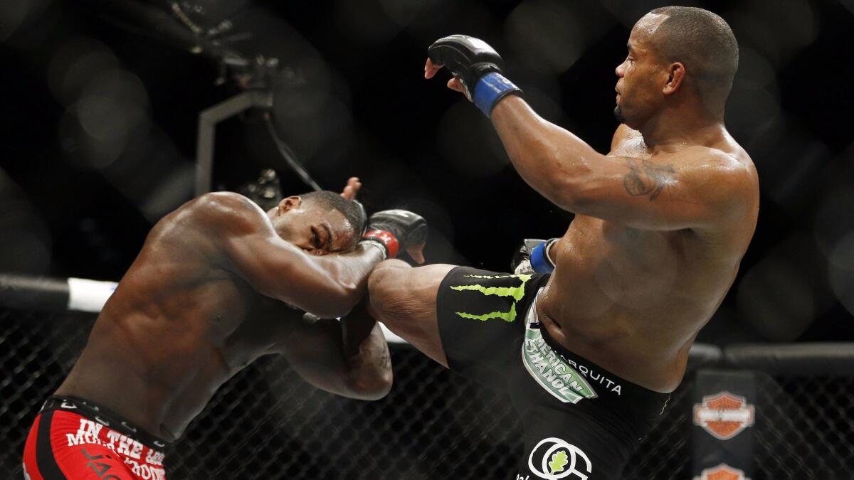 Daniel Cormier kicks Anthony Johnson during their light heavyweight title mixed martial arts bout at UFC 187 on Saturday, May 23, 2015, in Las Vegas. (AP Photo/John Locher)