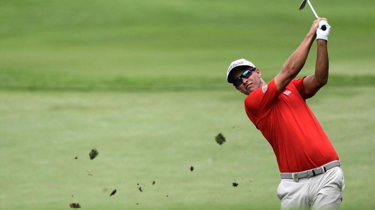 Adam Scott hits the ball onto the green of the ninth hole during the SMBC Singapore Open golf tournament on Jan. 22.