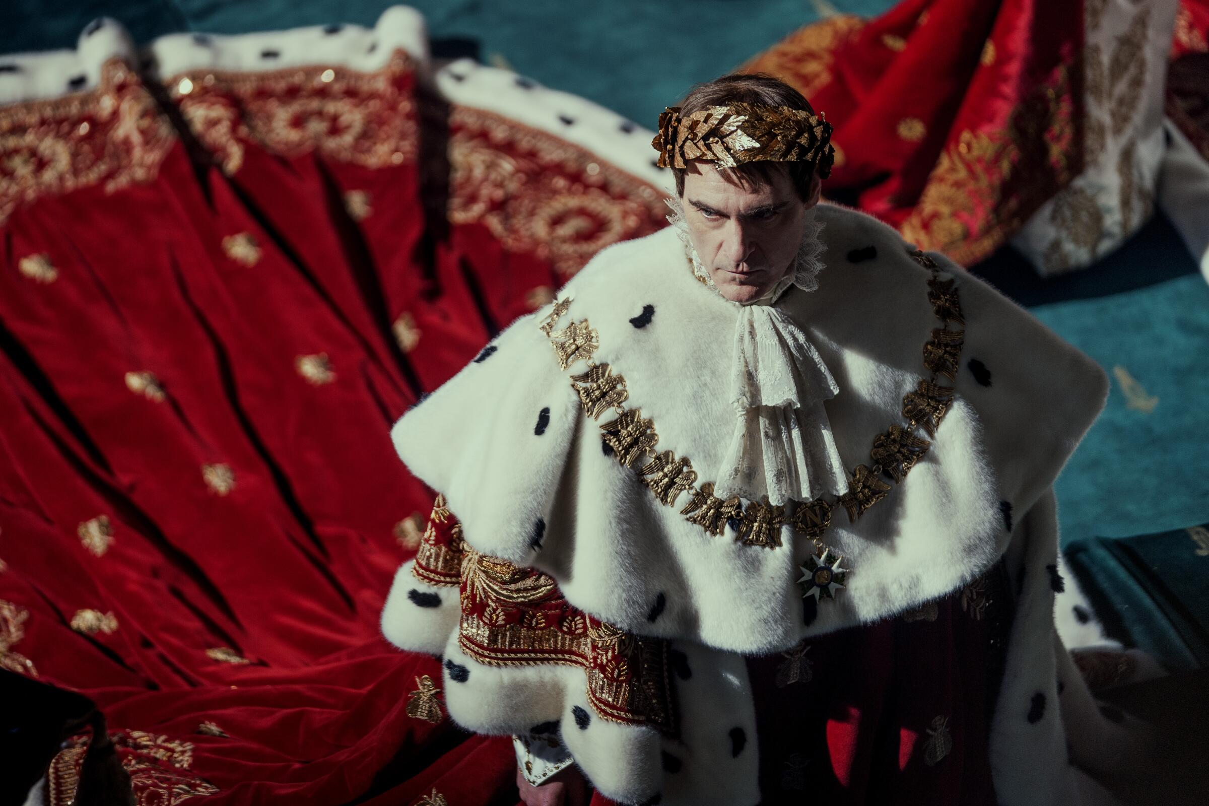 Napoleon wears a heavy, lush robe for an elaborate coronation scene in "Napoleon."