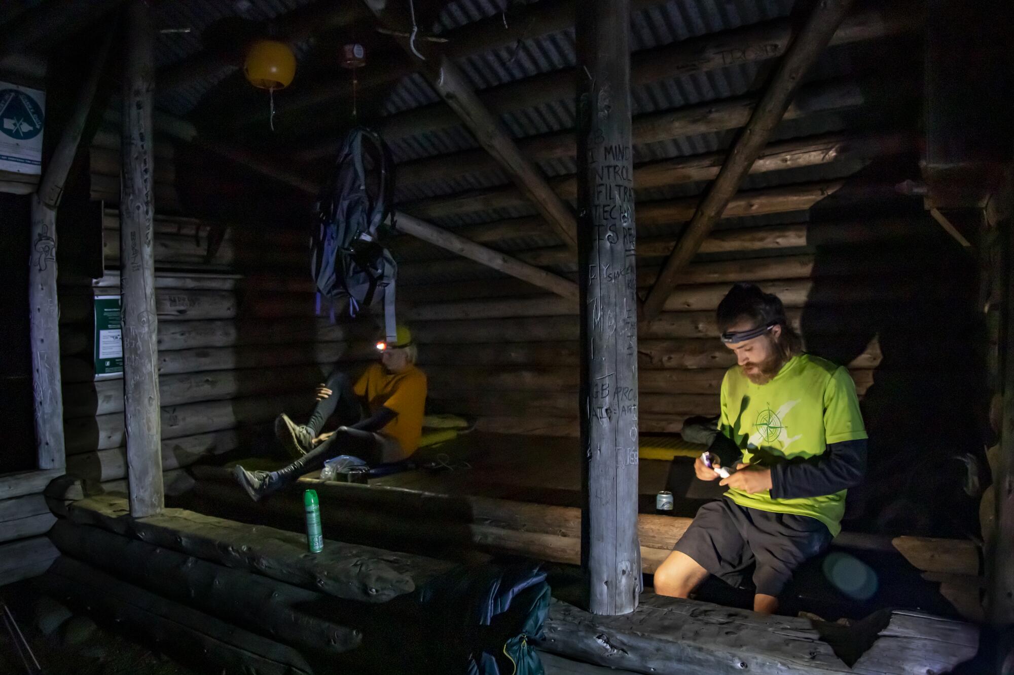 Potter and Parell prepare to bed down for the night in a lean-to