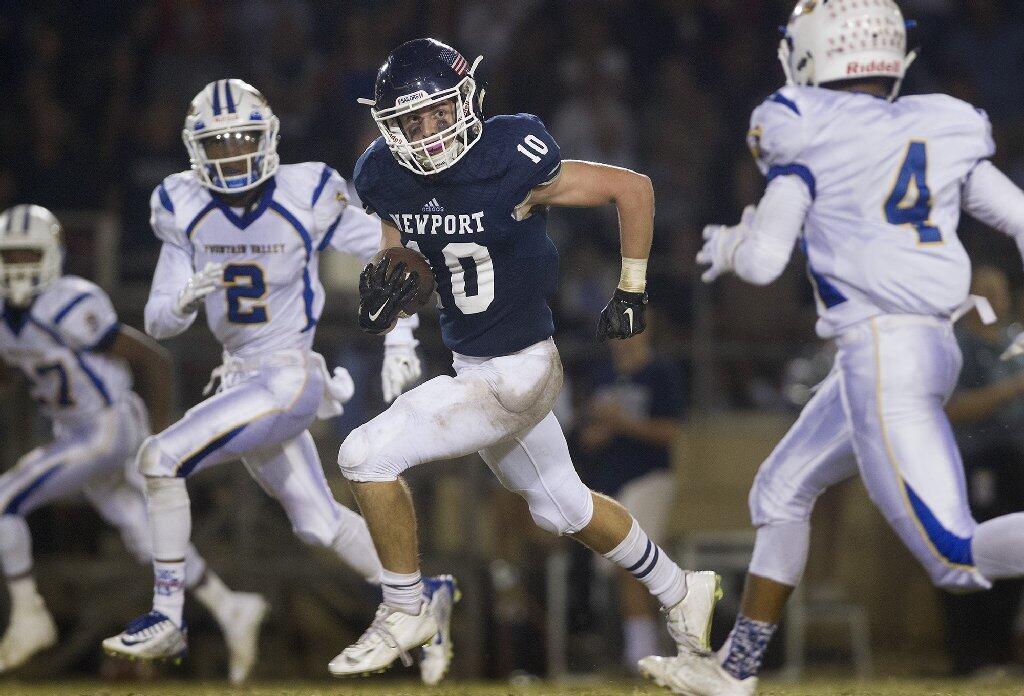 Newport Harbor High's Reed Rutter (10) carries the ball during the first half against Fountain Valley in a Sunset League season opener at Davidson Field on Thursday