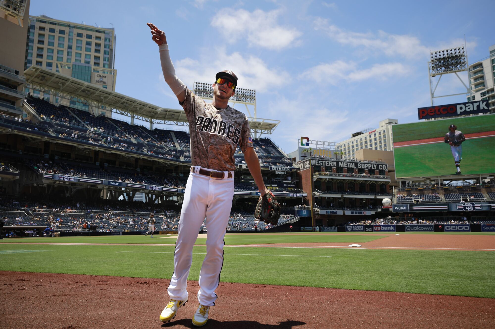 San Diego Padres' Wil Myers signals to fans as he takes the field to play.