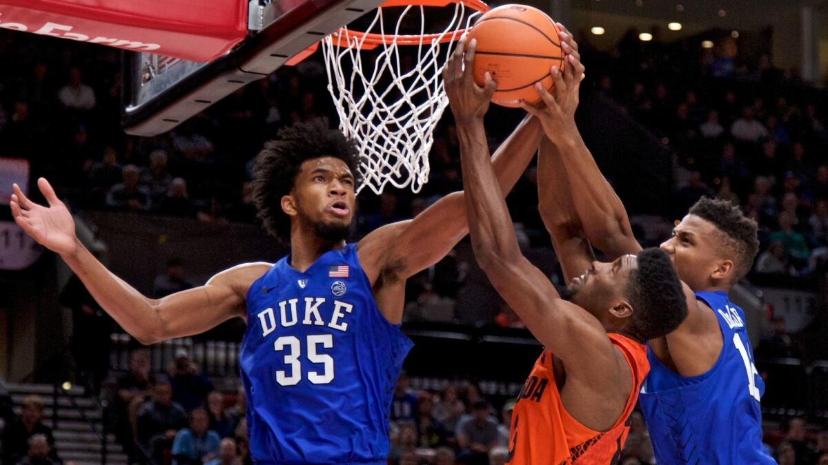 Duke forwards Marvin Bagley III (35) and Javin DeLaurier battle Florida forward Kevarrius Hayes for a rebound during the second half Sunday.