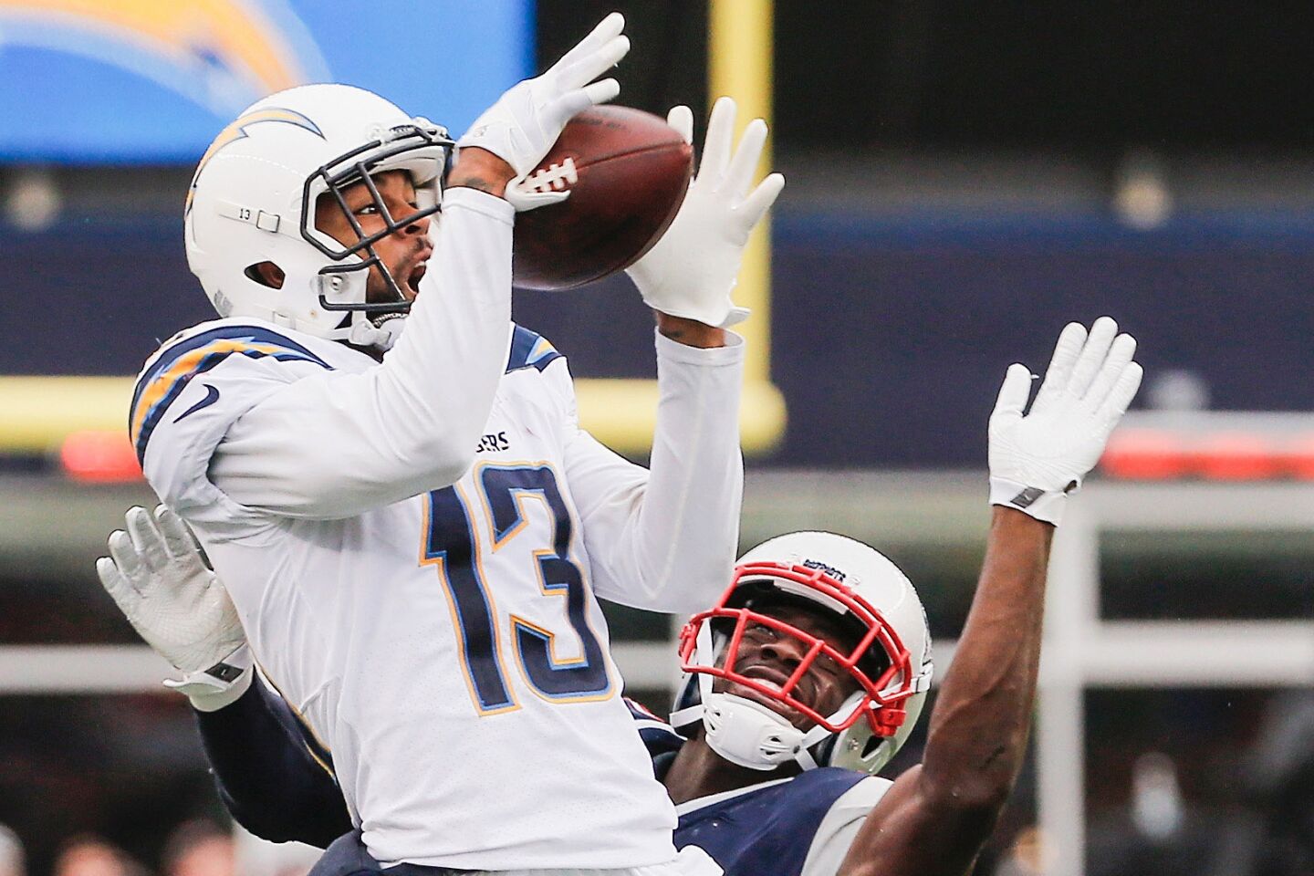 The Chargers' Keenan Allen catches a pass as he is defended by the Patriots' Johnson Bademosi during the third quarter.