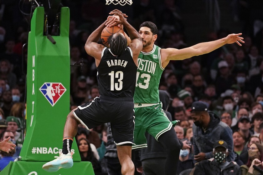 Boston Celtics center Enes Kanter, right, blocks Brooklyn Nets guard James Harden (13) during the first half of an NBA basketball game, Wednesday, Nov. 24, 2021, in Boston. (AP Photo/Charles Krupa)