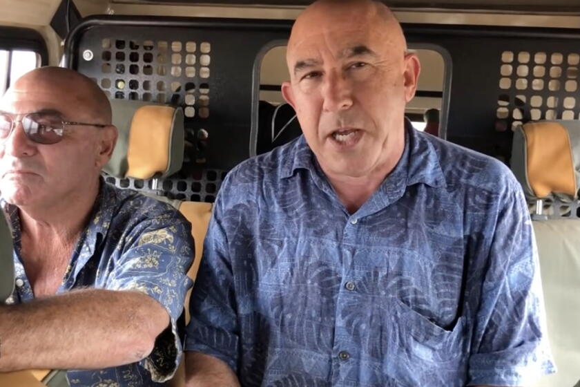 Riding in a jeep on a muddy road in Kenya is sportswriter Eric Sondheime.