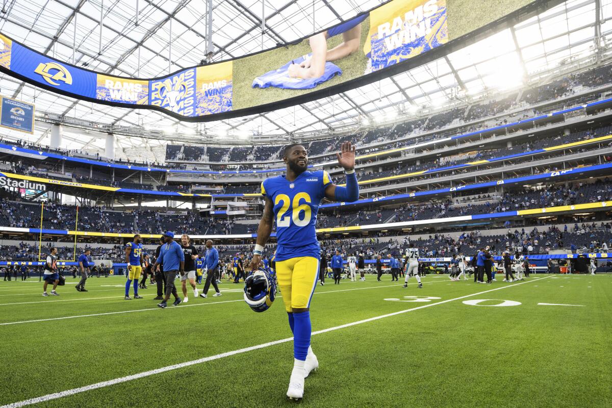Rams safety Terrell Burgess waves as he walks off the field following a win over the Carolina Panthers.