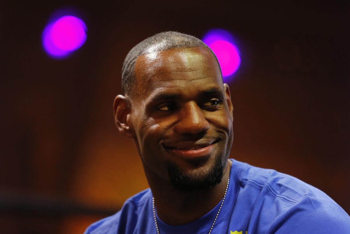 NBA star LeBron James attends a promotional event Saturday in Rio de Janeiro before going to the World Cup final on Sunday.