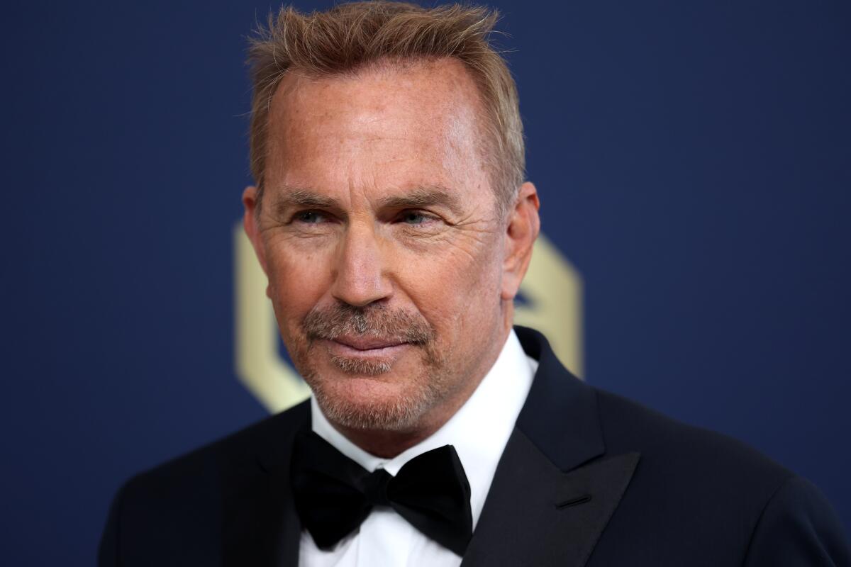Kevin Costner in a tuxedo and a black bow tie