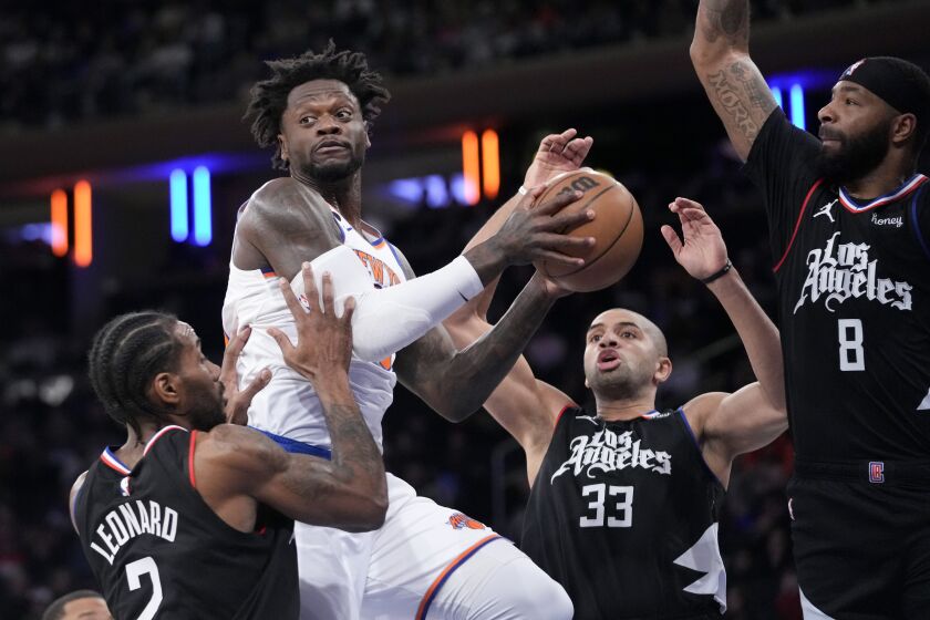 Los Angeles Clippers forwards Kawhi Leonard (2), Nicolas Batum (33) and Marcus Morris Sr. (8) guard against New York Knicks forward Julius Randle, second from left, in the first half of an NBA basketball game, Saturday, Feb. 4, 2023, at Madison Square Garden in New York. (AP Photo/Mary Altaffer)