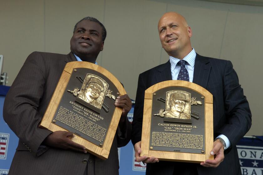 Cal Ripken Jr. and former San Diego Padre Tony Gwynn hold their Baseball Hall of Fame plaques after their induction in the the Baseball Hall of Fame.