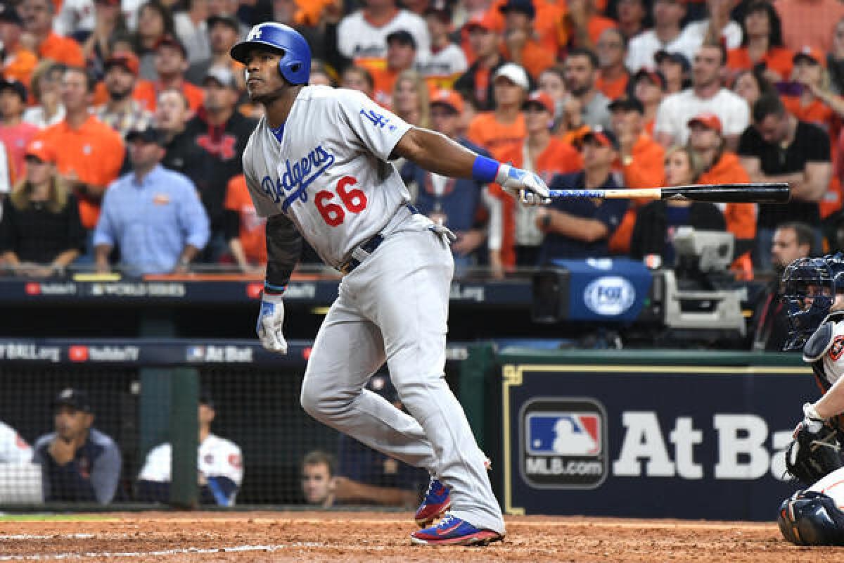 Yasiel Puig hits a two-run home run in the 9th inning. (Wally Skalij / Los Angeles Times)