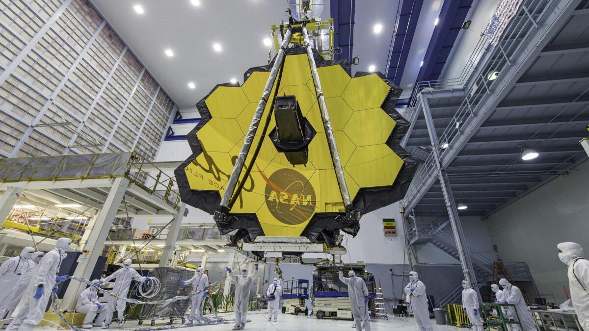 Technicians lift the mirror of the James Webb Space Telescope using a crane at the Goddard Space Flight Center in Greenbelt, Md., in April 2017.