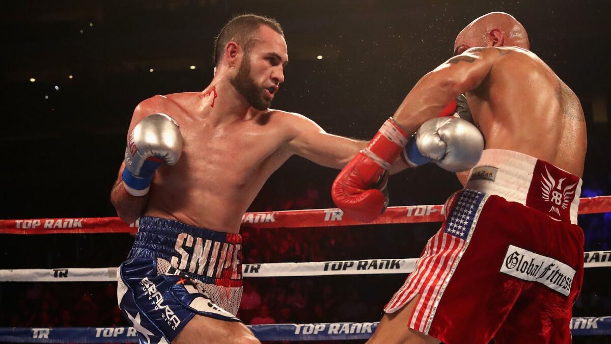 Jose Pedraza (L) of Puerto Rico fights Raymundo Beltran during the WBO lightweight championship bout at Gila River Arena in Glendale, Ariz,