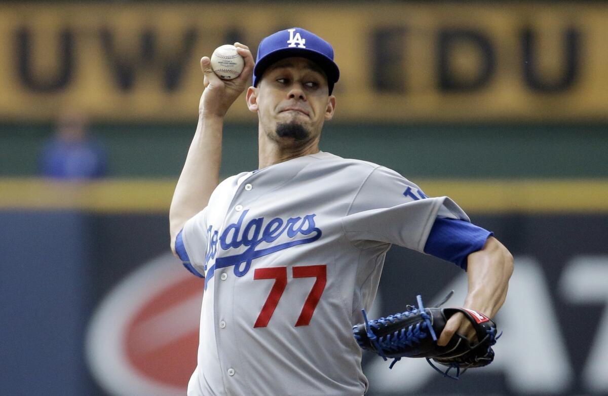 Dodgers starting pitcher Carlos Frias throws during the first inning of Thursday's afternoon game against the Brewers.