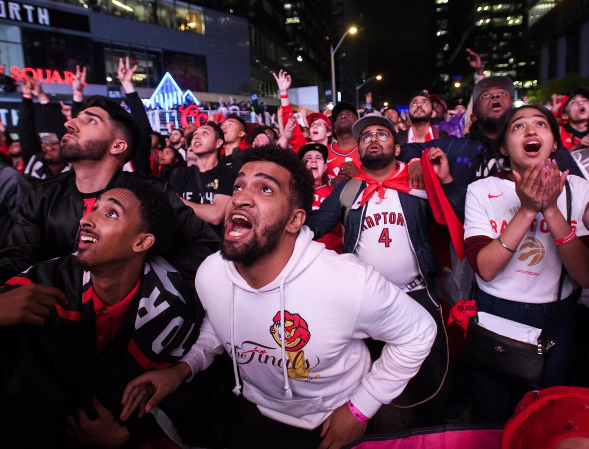 Fans on the streets of Toronto watch the final minute of Game 6.