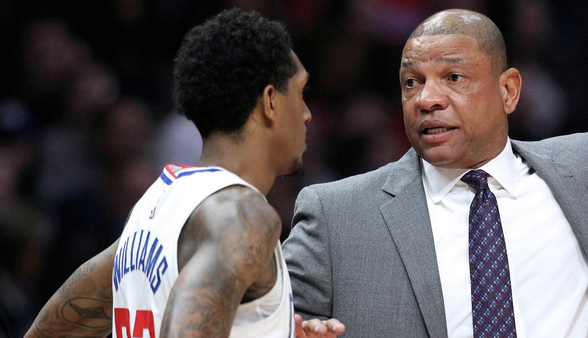 Clippers coach Doc Rivers and super-sub Lou Williams have a sideline talk during a break in play.