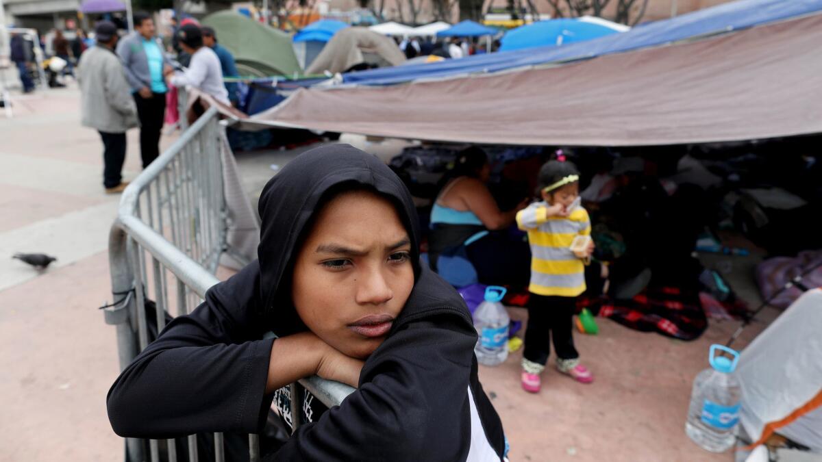Brian Casares, 12, of Honduras, along with other Central Americans, waits for an appointment to seek asylum at an encampment near the El Chaparral Port of Entry in Tijuana.