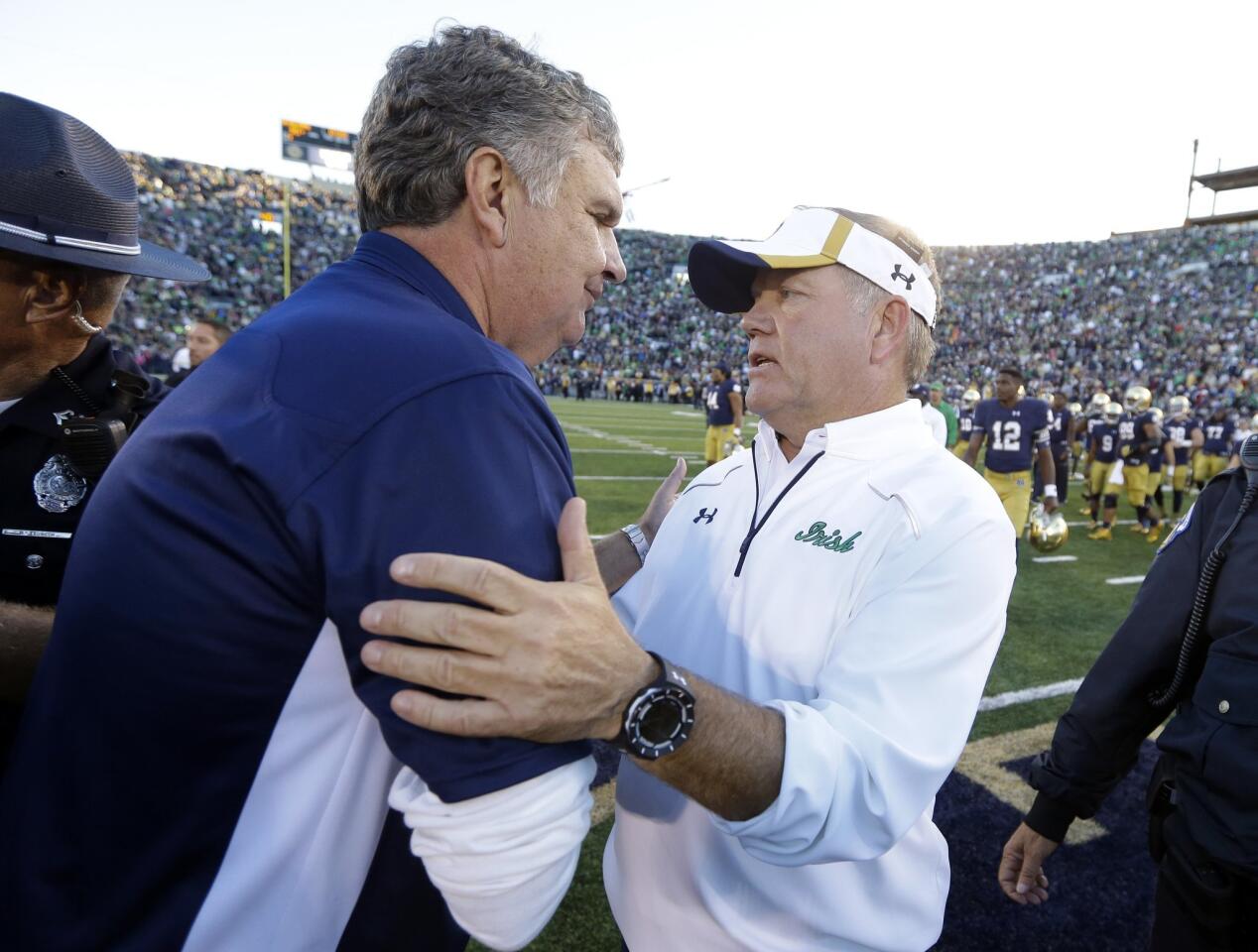 Notre Dame coach Brian Kelly is greeted by Georgia Tech coach Paul Johnson following the game.