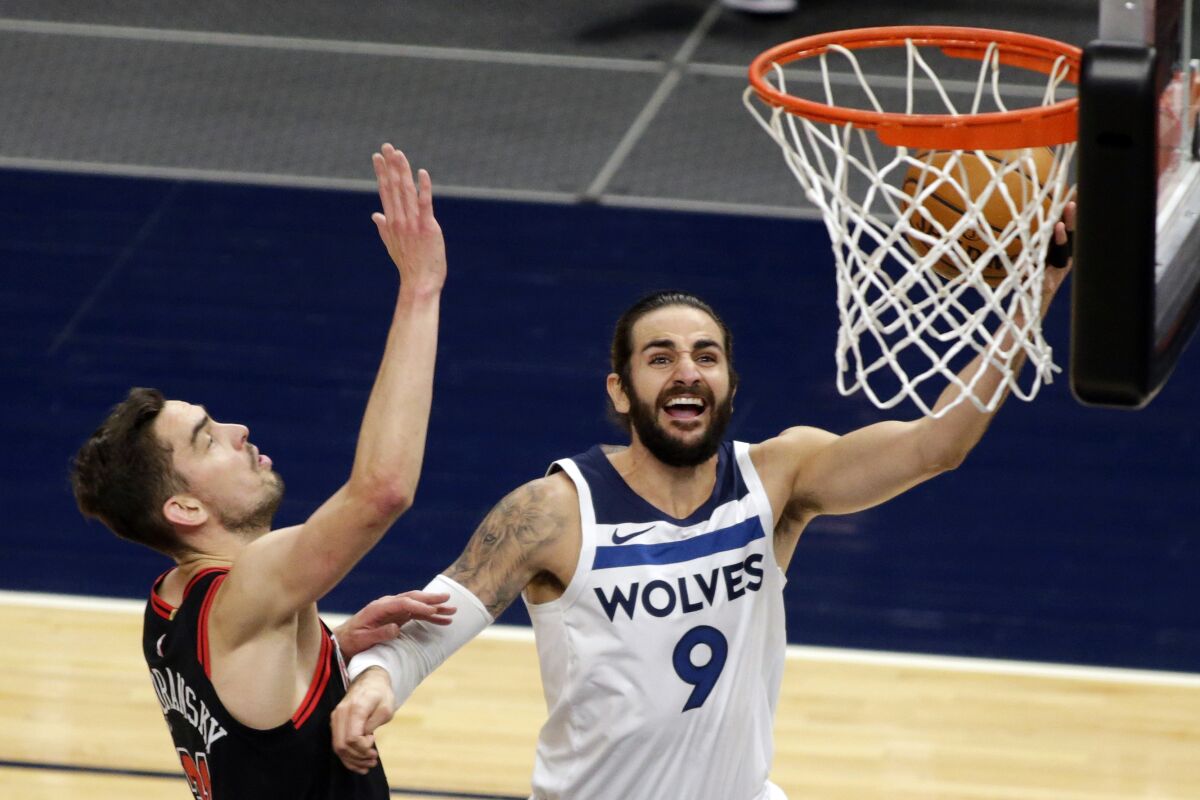 Minnesota Timberwolves guard Ricky Rubio (9) shoots as Chicago Bulls guard Tomas Satoransky (31) defends in the first quarter of an NBA basketball game, Sunday, April 11, 2021, in Minneapolis. (AP Photo/Andy Clayton-King)