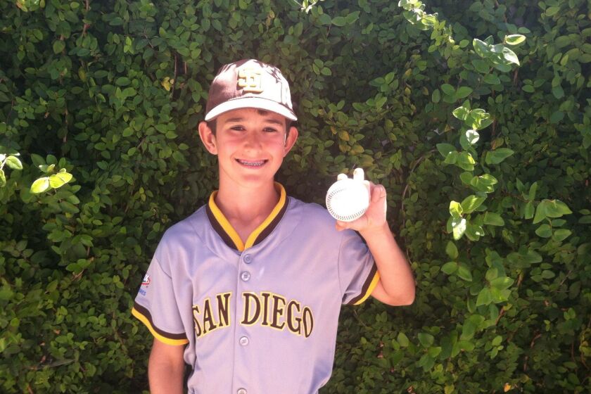 Bronco player Manny Butler shows off his Grand Slam ball that led to Sector 9 defeating Mission Bay 13-12.