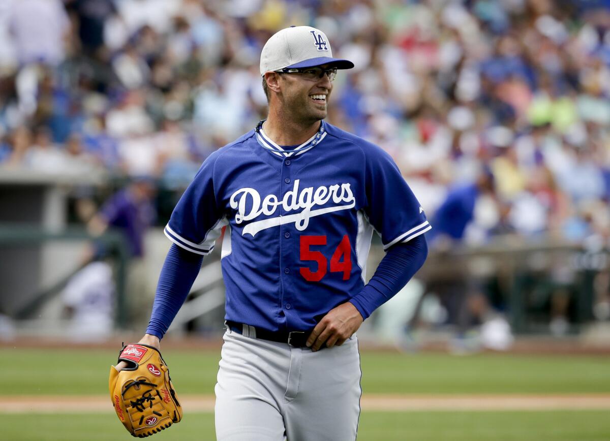Dodgers pitcher David Huff smiles as he walks off the mound during a spring training game last month.