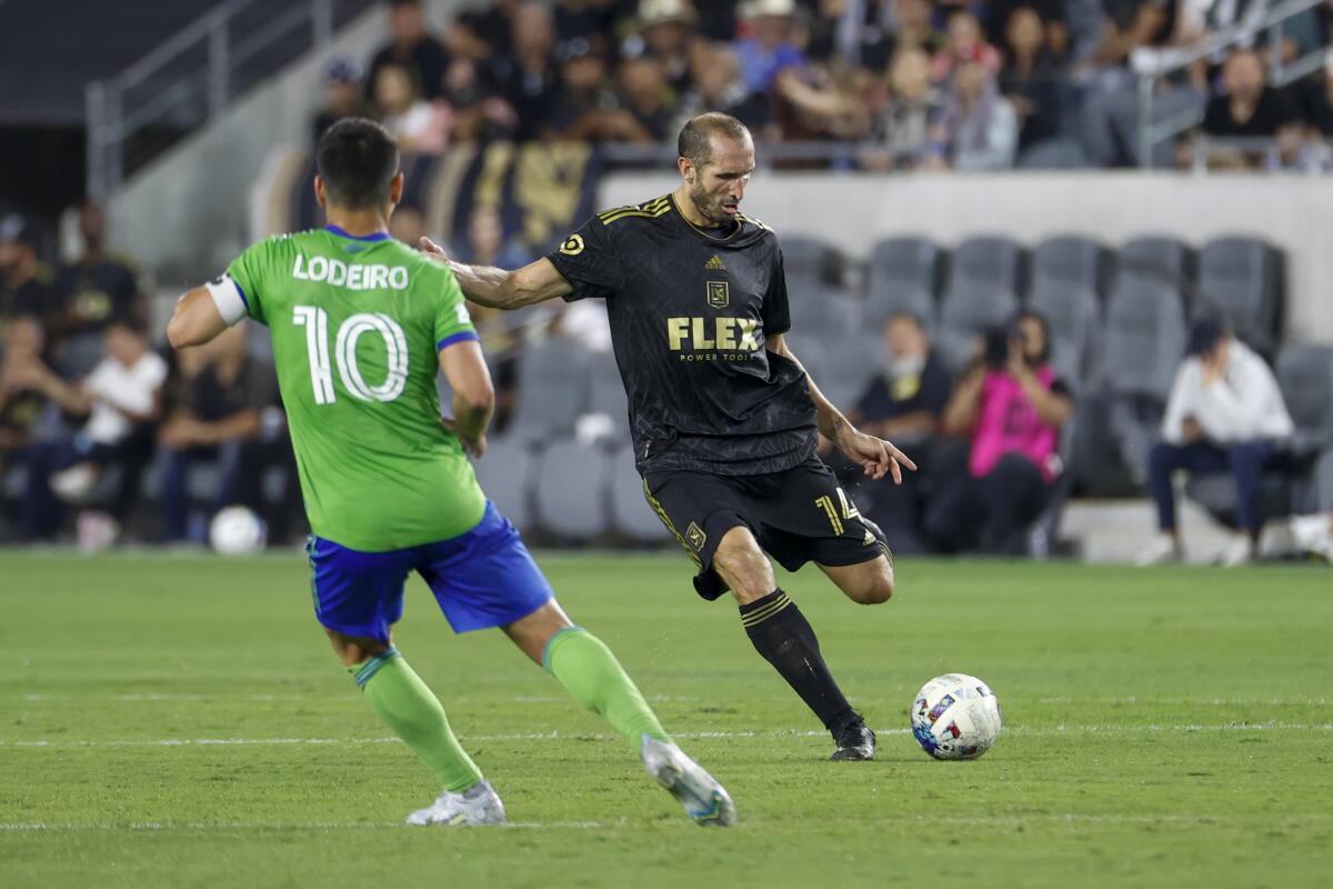 LAFC defender Giorgio Chiellini passes the ball in front of Seattle Sounders midfielder Nicolas Lodeiro.