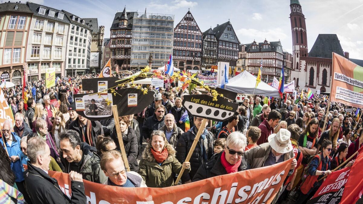 Participants in an Easter peace march gather near the old town hall in Frankfurt, Germany, in April.