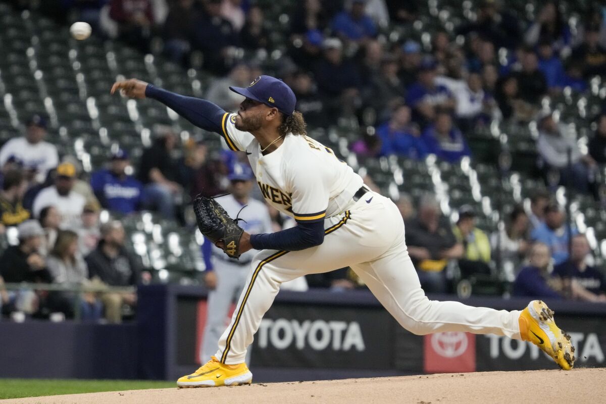 Milwaukee Brewers starting pitcher Freddy Peralta delivers against the Dodgers in the first inning on Monday.