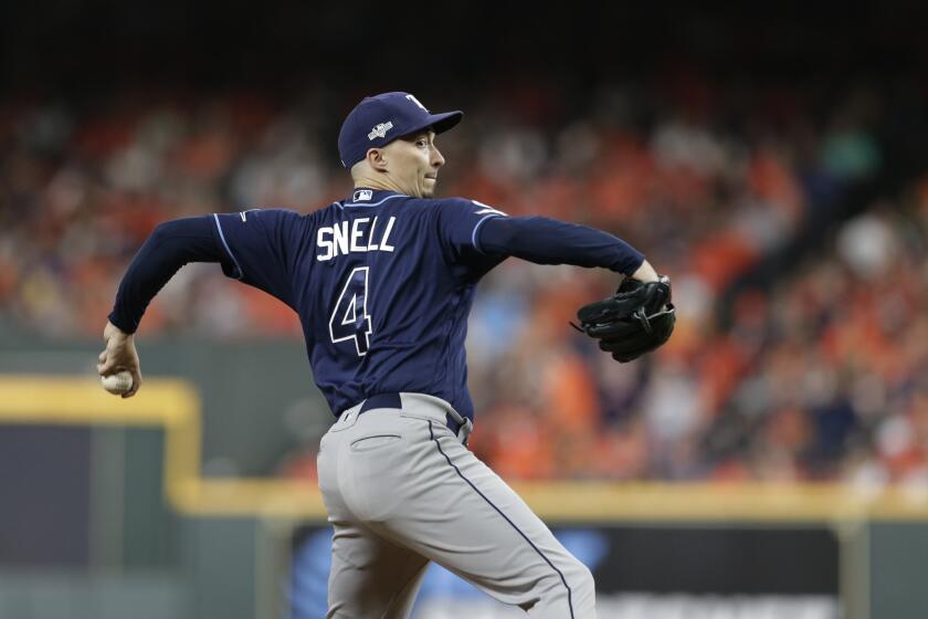 Tampa Bay Rays starting pitcher Blake Snell (4) pitches against the Houston Astros during the third inning of Game 5 of a baseball American League Division Series in Houston, Thursday, Oct. 10, 2019. (AP Photo/Michael Wyke)