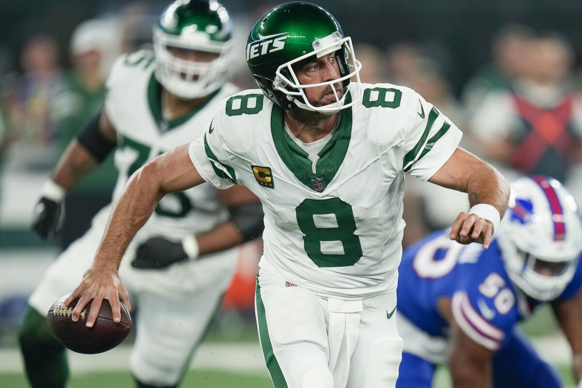 New York Jets quarterback Aaron Rodgers looks to throw in the the first quarter against the Buffalo Bills.