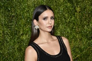 Nina Dobrev in black gown and floral earrings at the 2023 Chanel Tribeca Artists Dinner at Balthazar in New York