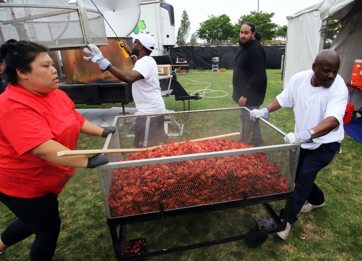 Fresh boiled Louisiana crawfish is wheeled to the serving area at Fountain Valley Sports Park on Friday.
