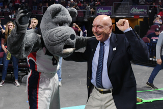LAS VEGAS, NEVADA - MARCH 10: Sportscaster Dick Vitale dances with the Gonzaga Bulldogs mascot Spike.