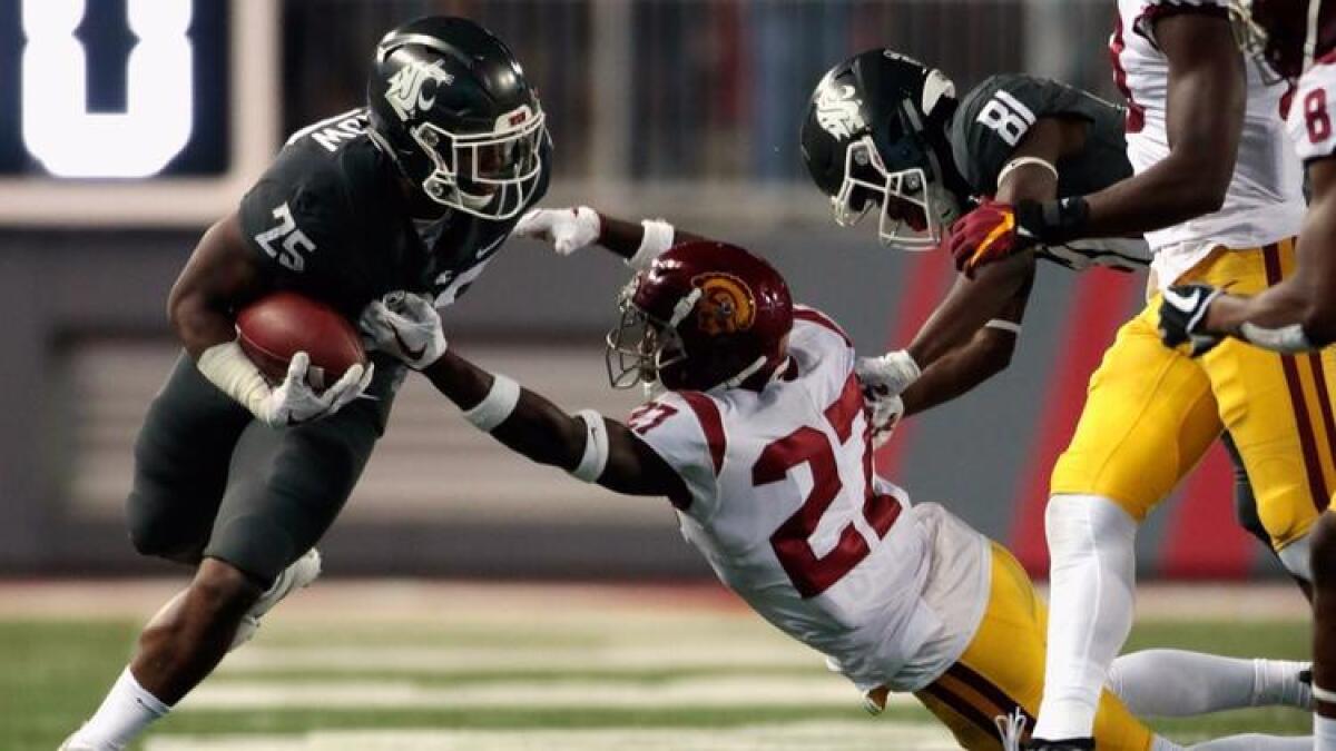 Washington State's Jamal Morrow (25) carries the ball against USC's Aiene Harris (27) in the second half on Sept. 29. Washington State defeated USC 30-27.