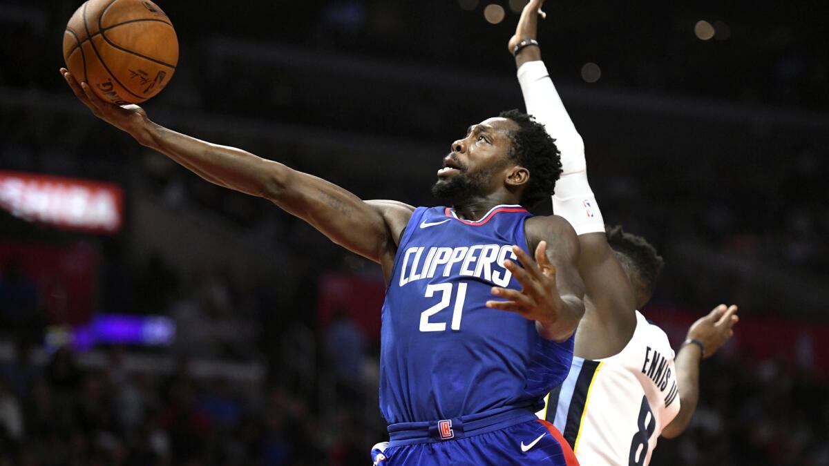 Clippers guard Patrick Beverley attempts a layup against Grizzlies forward James Ennis III during a game Nov. 4.