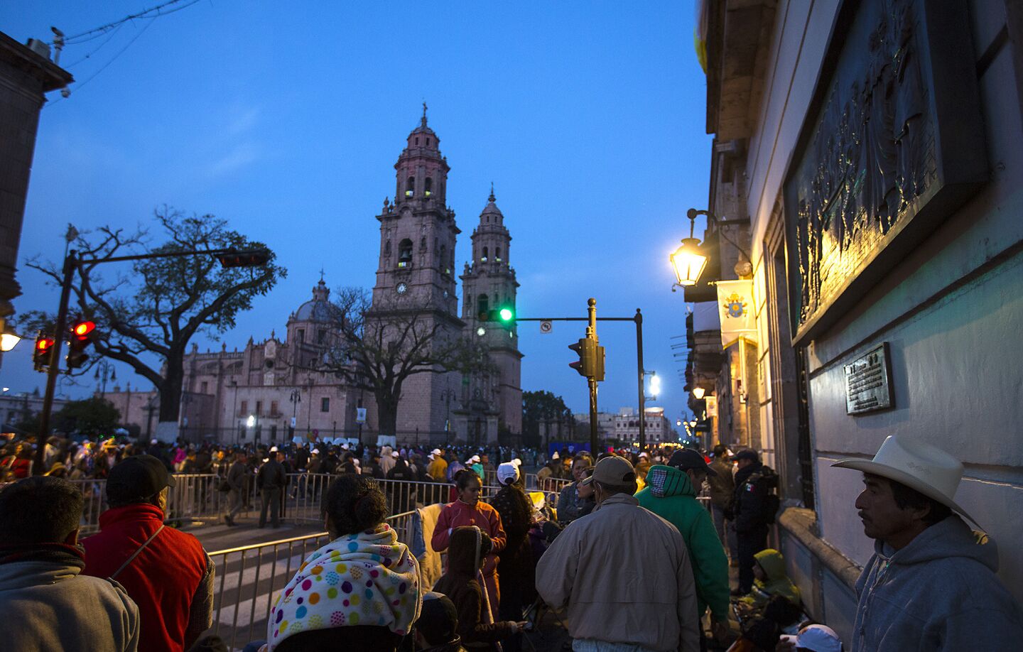 People stake out spots at dawn near the cathedral to see the Pope arrive in Morelia, Michoacan.