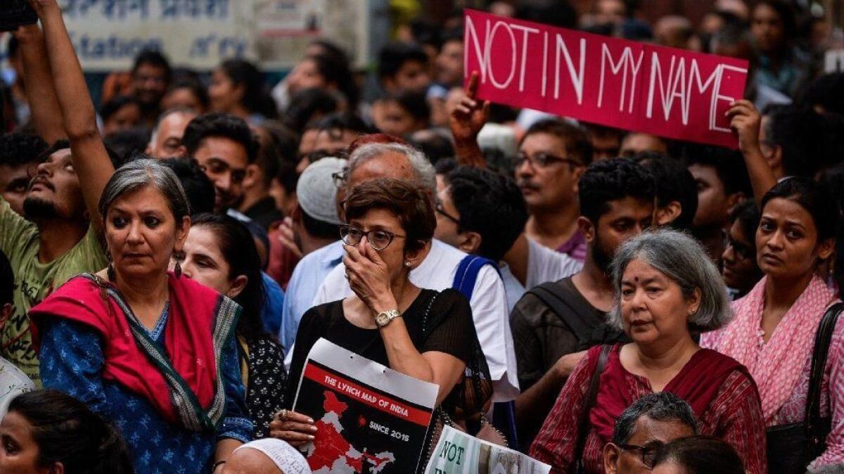 Indian protesters hold placards at a silent protest in New Delhi on June 28, 2017, in response to a spate of anti-Muslim killings.