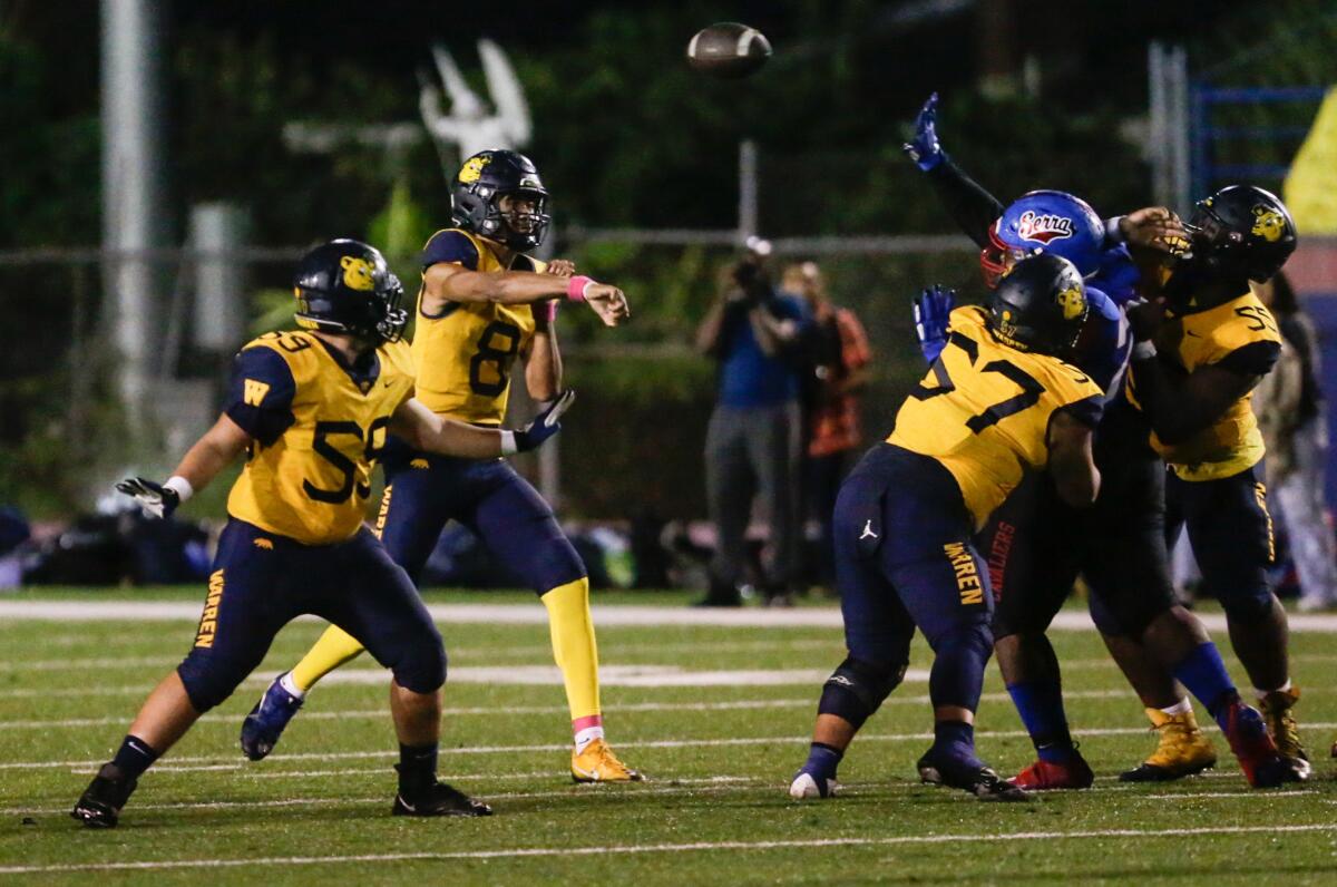 Warren quarterback Nico Iamaleava makes a pass from the pocket.