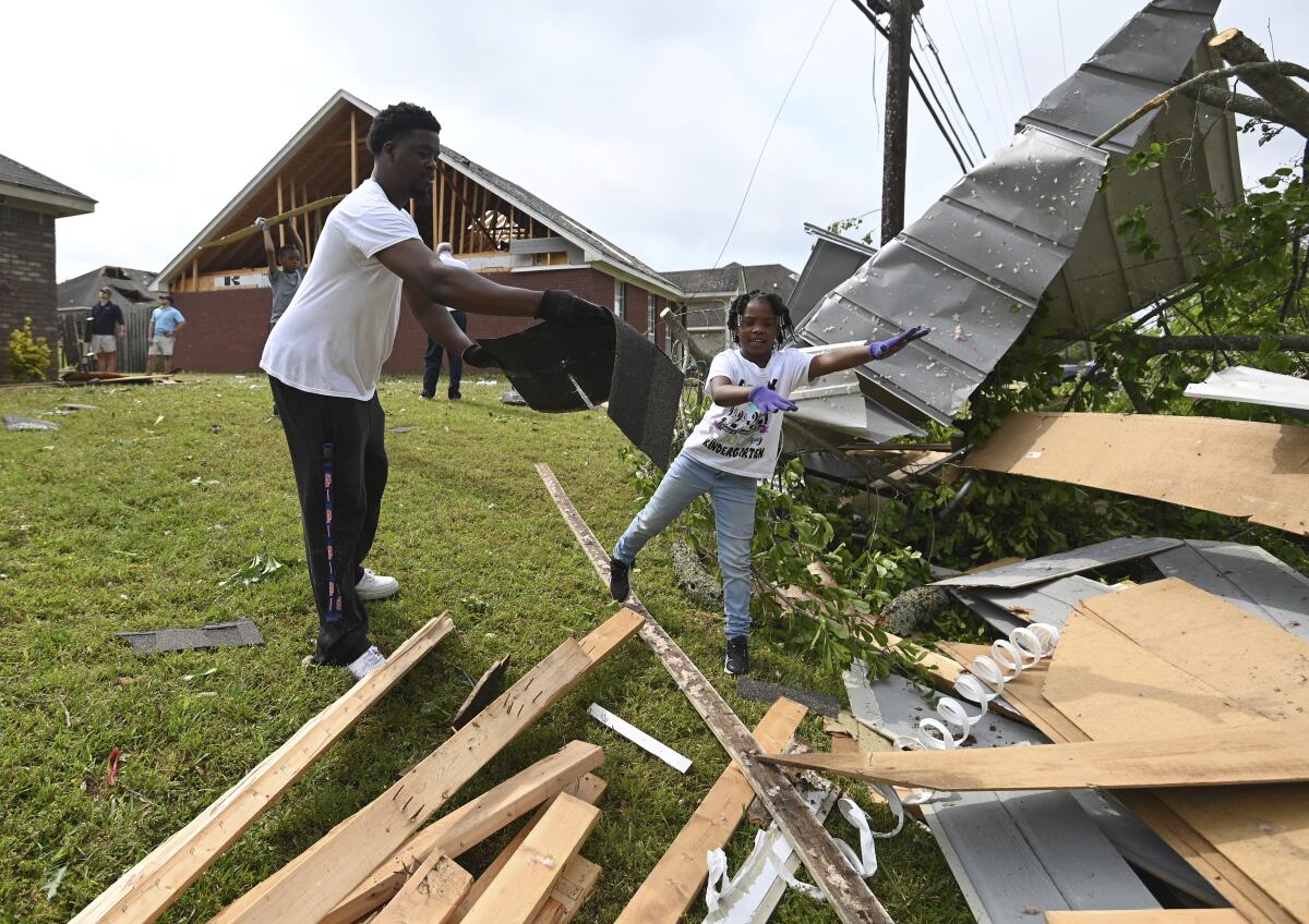 Father and daughter cleaning up storm debris
