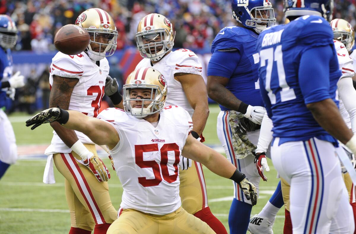 San Francisco linebacker Chris Borland celebrates after intercepting a pass during the first half of a game Nov. 16 against the New York Giants. Borland announced his retirement from the NFL on Monday.