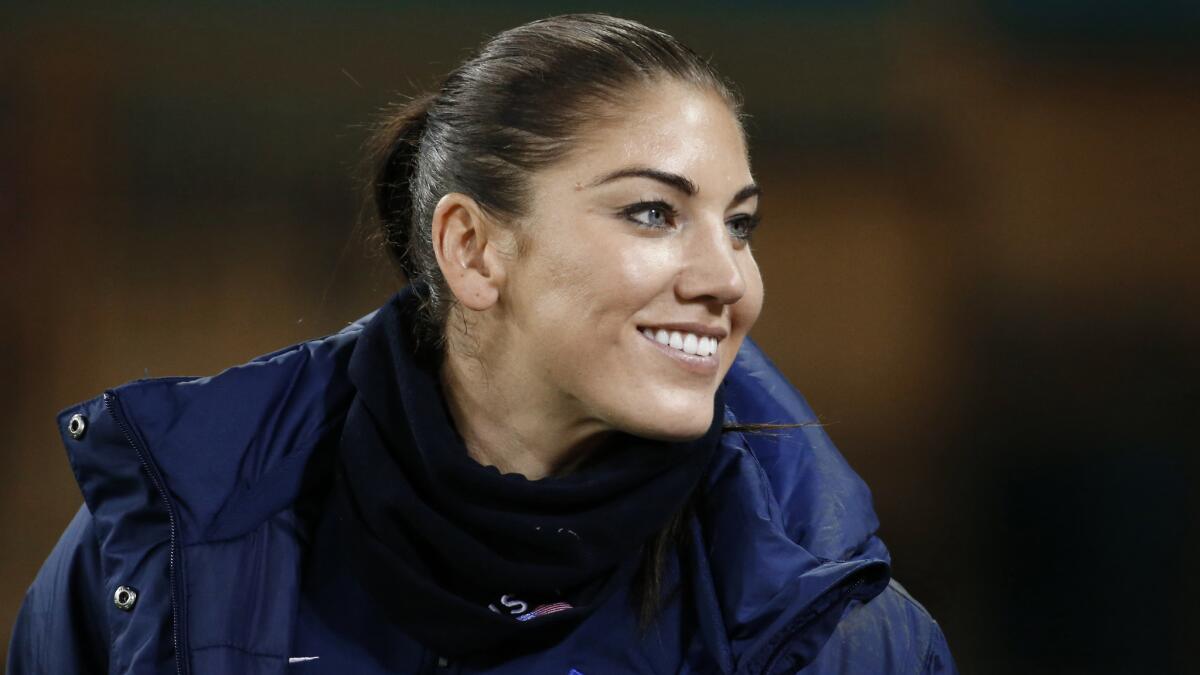 U.S. goalkeeper Hope Solo smiles on the sideline before a match against Haiti in Washington on Oct. 20. Solo was reinstated by the U.S. women's national team Saturday.