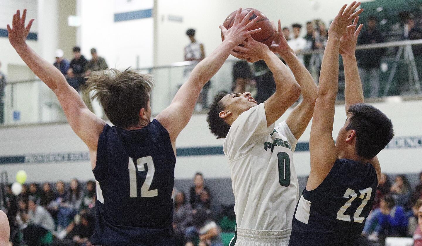 Providence's Jordan Shelley gets to the basket to shoot under defensive pressure from Flintridge Prep's Kevin Ashworth and Zach Kim in a Prep League boys' basketball game at Providence High School auditorium on Tuesday, January 22, 2019.