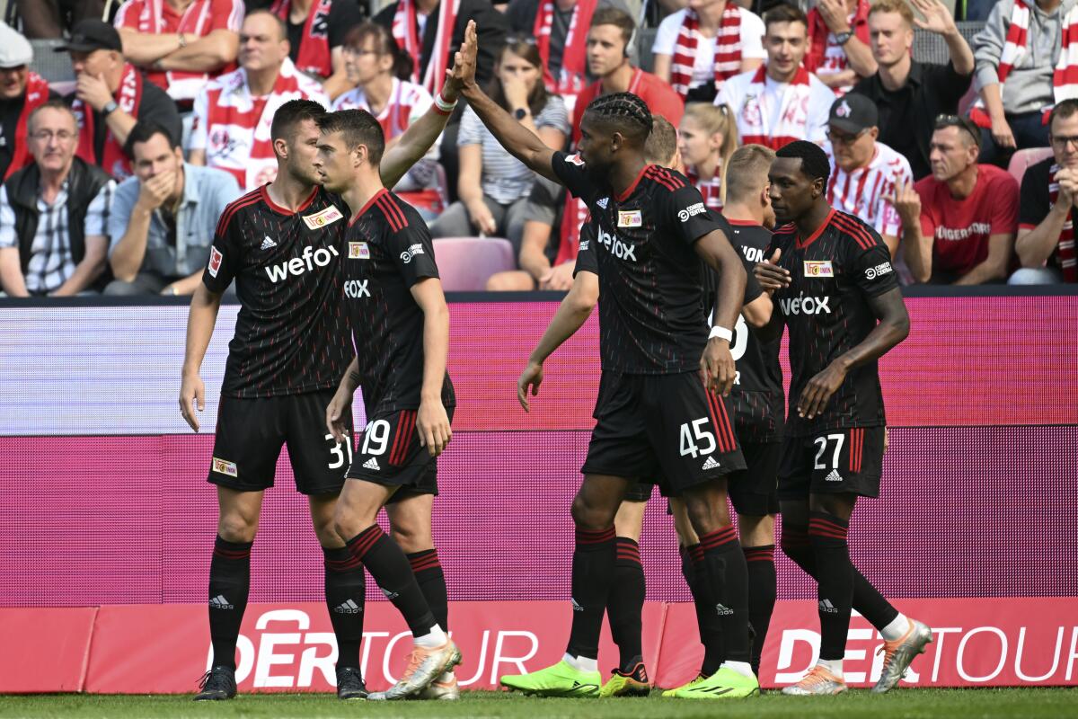 Union's players celebrate the opening goal during the German Bundesliga soccer match between 1. FC Cologne and 1. FC Union Berlin in Cologne, Germany Sunday, Sept. 11, 2022. Union Berlin fans are reveling in the view from the top of the Bundesliga for the first time this week. “Other times will come but let us enjoy the moment,” the club said on Twitter after Sunday’s 1-0 win in Cologne lifted Urs Fischer’s team top of Germany’s first division after six rounds. (Federico Gambarini/dpa via AP)