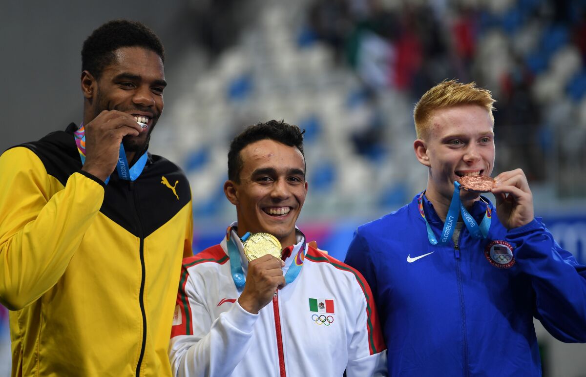 (L to R) Jamaica's Yona Knight-Wisdom, Mexico's Juan Manuel Celaya and US Andrew Capobianco pose at the podium of the Men's 1m Springboard during the Lima 2019 Pan-American Games in Lima on August 1, 2019. (Photo by PEDRO PARDO / AFP)PEDRO PARDO/AFP/Getty Images ** OUTS - ELSENT, FPG, CM - OUTS * NM, PH, VA if sourced by CT, LA or MoD **